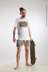 Nigel Standing Pose With Skateboard